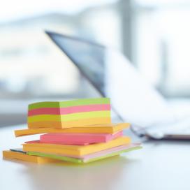 Post-It notes and laptop on desk